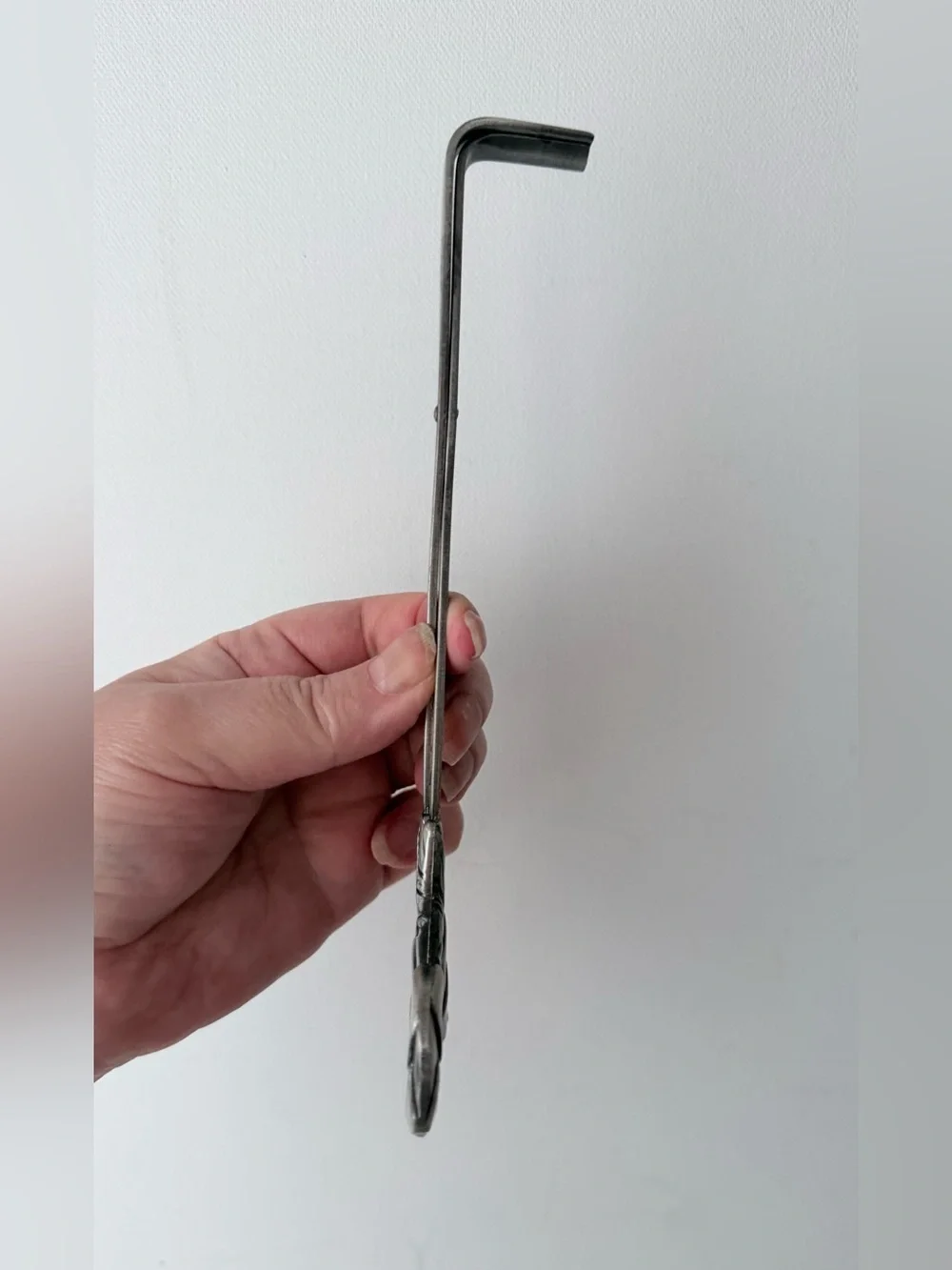 vintage pewter wick trimmer featuring a detailed repoussé leaf design